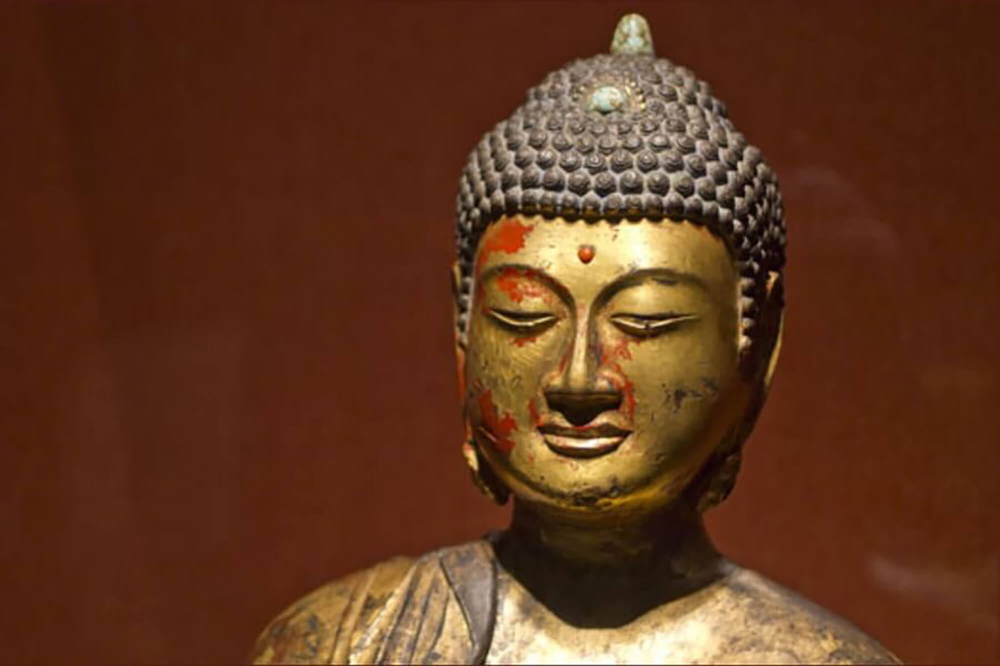 Close-up of a Buddha statue used for artwork authenticity analysis