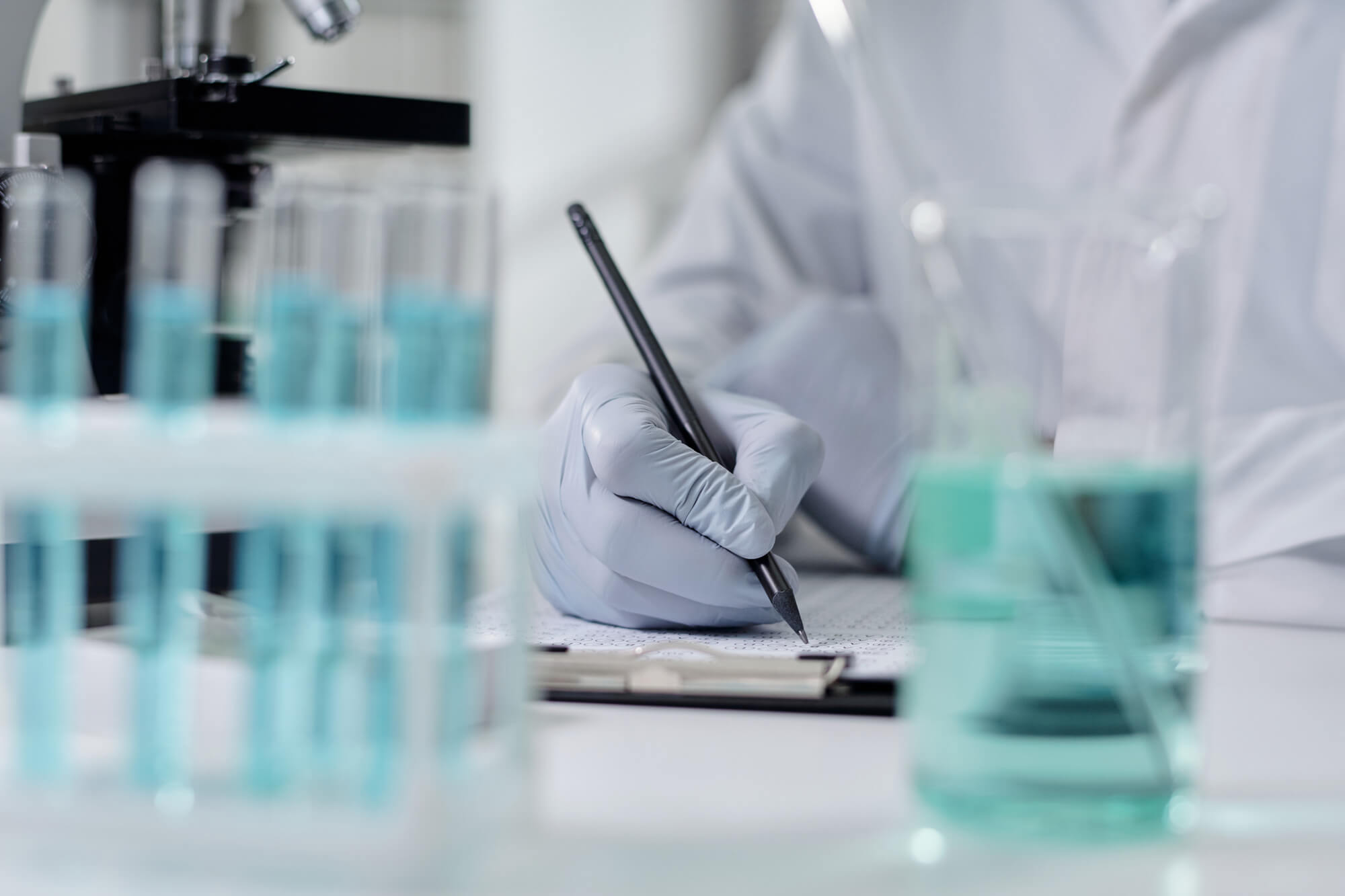 A scientist recording analytical results in a laboratory